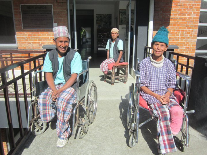 © Tom Bradley/The Leprosy Mission Nepal (TLMN) Patients enjoy the winter sun outside TLMN’s Anandaban Hospital Leprosy Ward. Amputated feet highlight delayed diagnosis and the continued need for contact survey, self-care and awareness raising.