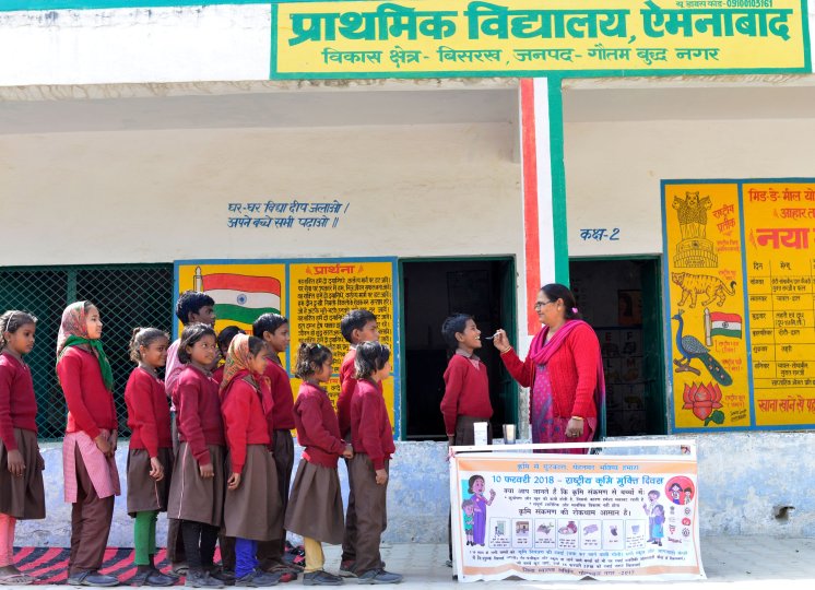 © Evidence Action School children line up to get their dose of albendazole on National Deworming Day. National Deworming Day is the largest single-day preschool and school-based deworming programme in the world.