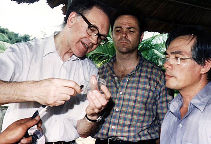 Milking a Malayan krait of its venom with Jeremy Farrar and Trinh Xuan Kiem in Ho Chi Minh City, Vietnam, 1996 