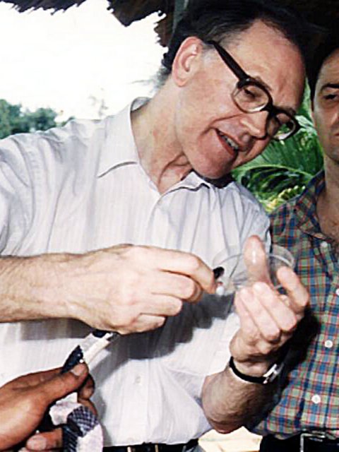 Milking a Malayan krait of its venom with Jeremy Farrar and Trinh Xuan Kiem in Ho Chi Minh City, Vietnam, 1996