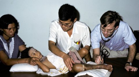 Sornchai Looareesuwan and Rodney Phillips assessing a child bitten by a Malayan pit viper in Trang, Southern Thailand, 1985 Sornchai Looareesuwan and Rodney Phillips assessing a child bitten by a Malayan pit viper in Trang, Southern Thailand, 1985